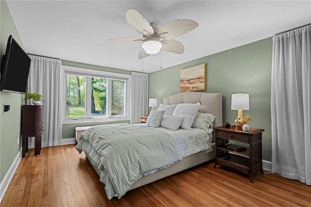 bedroom with wood-type flooring, baseboards, and ceiling fan