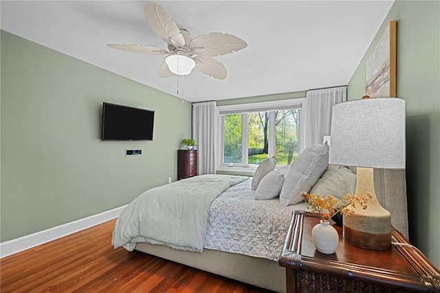 bedroom featuring baseboards, ceiling fan, and wood finished floors