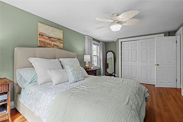 bedroom with a closet, ceiling fan, and wood finished floors