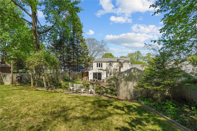 view of yard with a fenced backyard and an outdoor structure