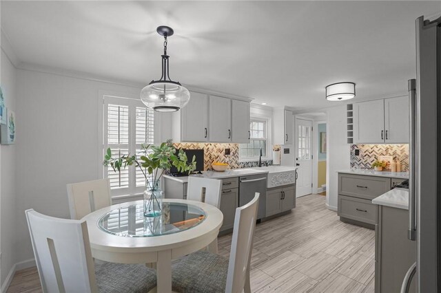 dining room featuring crown molding and light wood-style floors