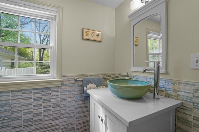 bathroom featuring vanity, tile walls, and a wainscoted wall