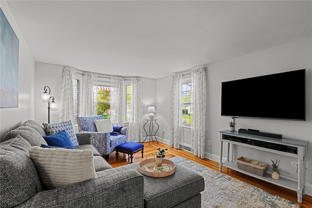 living room featuring baseboards and wood finished floors