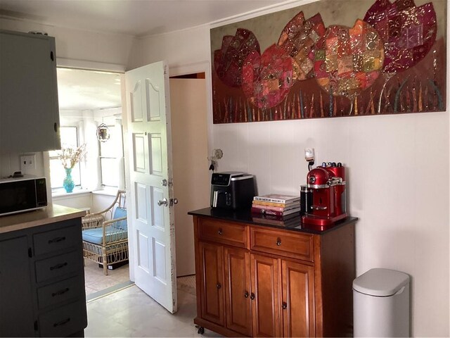 446 Carrington Ave, Woonsocket, RI 02895 - interior space with dark countertops, light floors, and brown cabinets