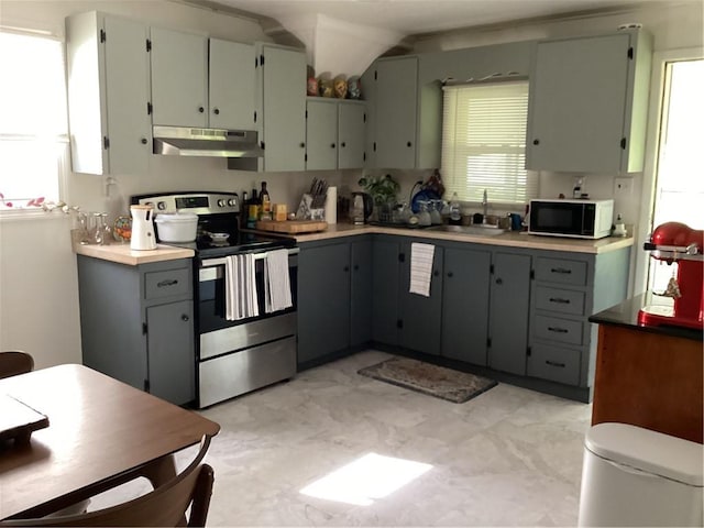 446 Carrington Ave, Woonsocket, RI 02895 - kitchen with black microwave, stainless steel range with electric cooktop, gray cabinetry, a sink, and under cabinet range hood