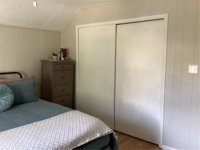 446 Carrington Ave, Woonsocket, RI 02895 - bedroom featuring a closet, vaulted ceiling, and wood finished floors