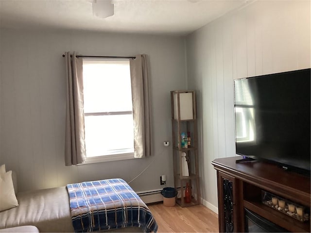 446 Carrington Ave, Woonsocket, RI 02895 - bedroom featuring light wood finished floors, baseboard heating, and multiple windows