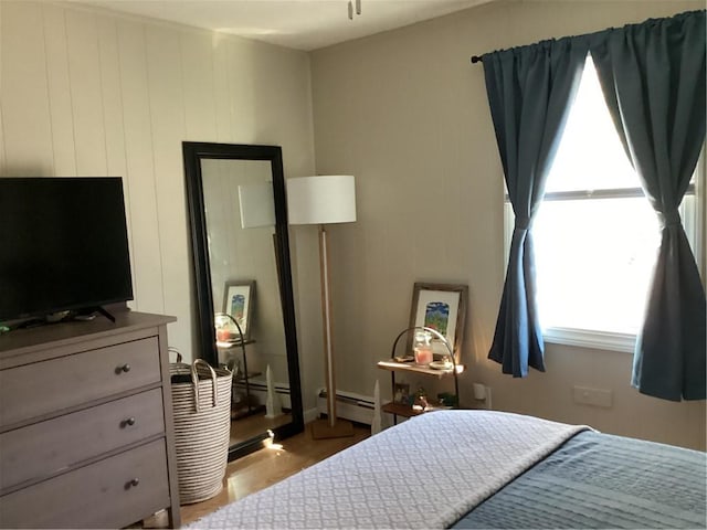 446 Carrington Ave, Woonsocket, RI 02895 - bedroom with a baseboard radiator and wood finished floors
