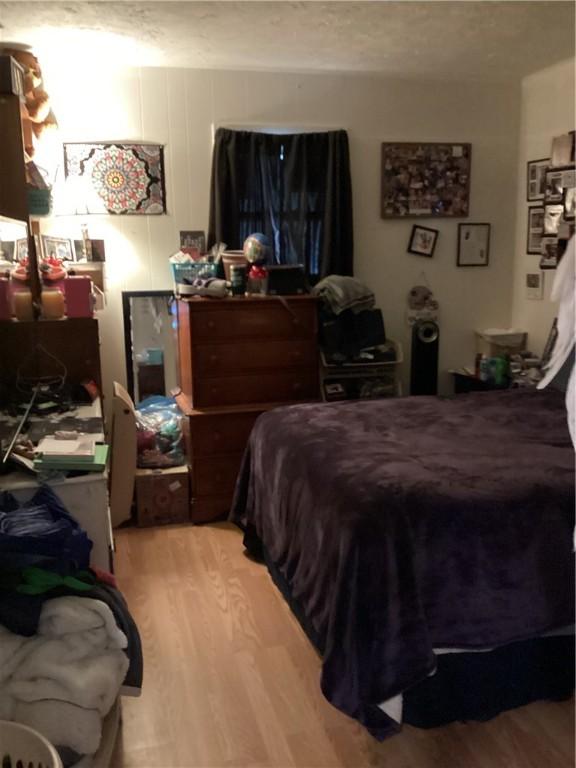 446 Carrington Ave, Woonsocket, RI 02895 - bedroom featuring a textured ceiling and wood finished floors