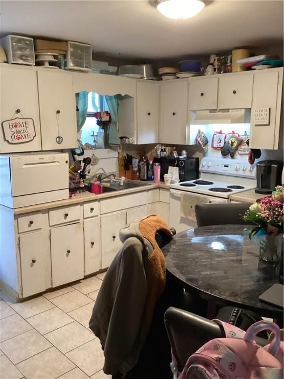 446 Carrington Ave, Woonsocket, RI 02895 - kitchen with black microwave, light tile patterned flooring, white cabinetry, under cabinet range hood, and white electric stove