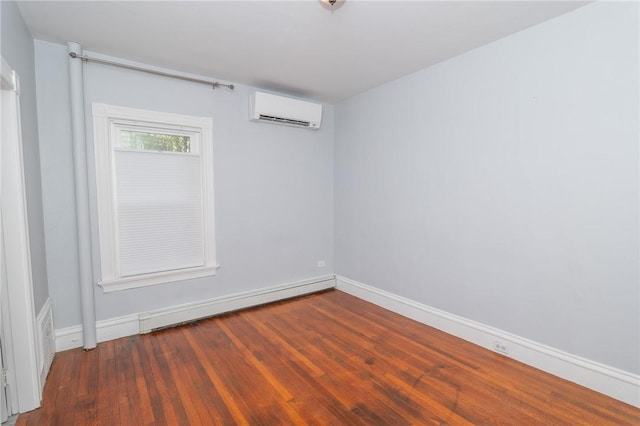 unfurnished room featuring a baseboard heating unit, baseboards, a wall mounted AC, and wood finished floors
