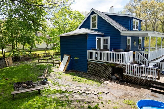 71 Centennial St, Burrillville, RI 02859 - back of property featuring a deck, a chimney, a fire pit, and stairs