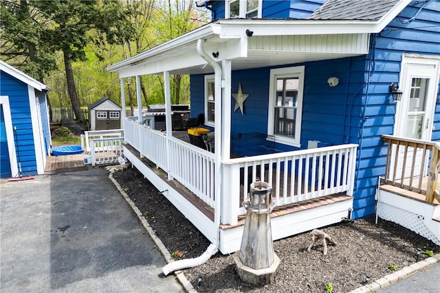 71 Centennial St, Burrillville, RI 02859 - property entrance with a porch and a shingled roof