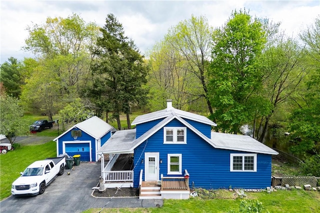 71 Centennial St, Burrillville, RI 02859 - view of front of home with a detached garage, covered porch, an outbuilding, and a front lawn