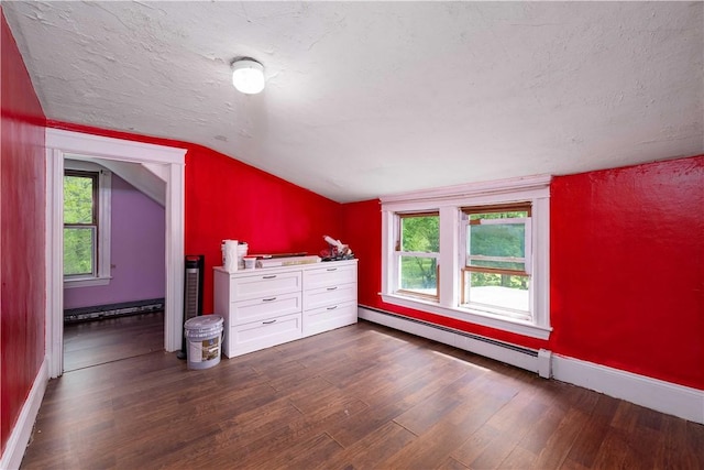 71 Centennial St, Burrillville, RI 02859 - unfurnished bedroom featuring a baseboard radiator, dark wood finished floors, vaulted ceiling, baseboards, and multiple windows