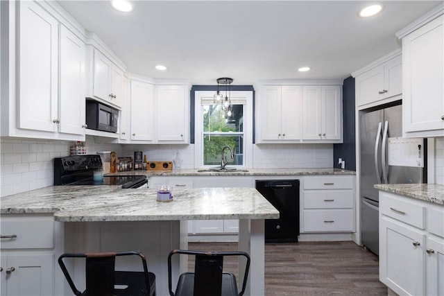 71 Centennial St, Burrillville, RI 02859 - kitchen featuring black appliances, a sink, a breakfast bar area, white cabinets, and backsplash