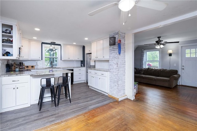 71 Centennial St, Burrillville, RI 02859 - kitchen featuring ceiling fan, a peninsula, white cabinets, backsplash, and recessed lighting