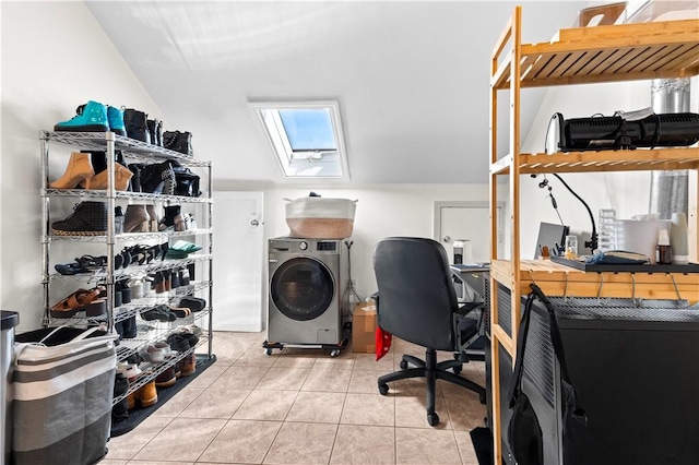 laundry room featuring a skylight, washer / dryer, tile patterned floors, and laundry area