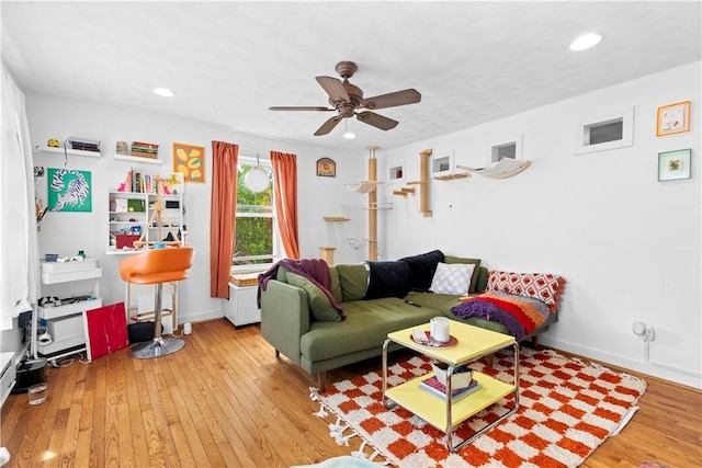 living room with baseboards, recessed lighting, ceiling fan, and wood finished floors