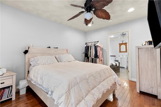 bedroom featuring recessed lighting, ensuite bathroom, a ceiling fan, and hardwood / wood-style flooring