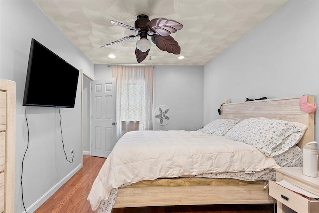 bedroom featuring recessed lighting, a ceiling fan, baseboards, and wood finished floors