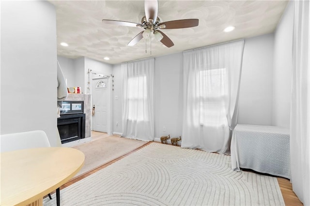 bedroom with a fireplace, a ceiling fan, and recessed lighting