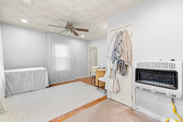 bedroom with heating unit, a ceiling fan, and recessed lighting