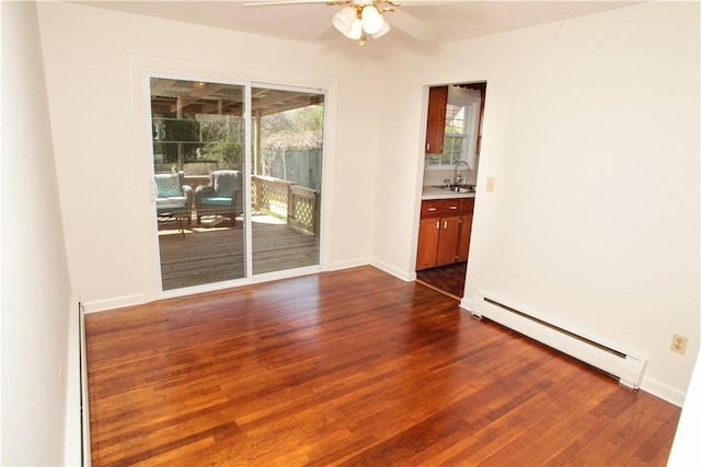 7 Smithfield Dr, Middletown, RI 02842 - unfurnished room featuring dark wood-type flooring, a sink, ceiling fan, and a baseboard heating unit
