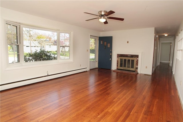 7 Smithfield Dr, Middletown, RI 02842 - unfurnished living room with a brick fireplace, a ceiling fan, baseboards, wood finished floors, and a baseboard radiator