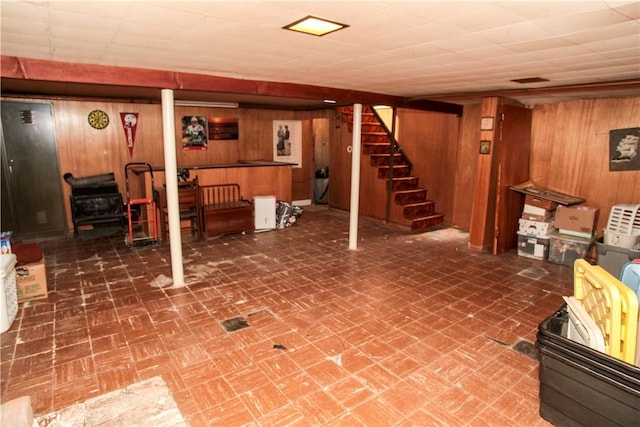 7 Smithfield Dr, Middletown, RI 02842 - finished basement featuring wood walls, a wood stove, brick patterned floor, and stairway