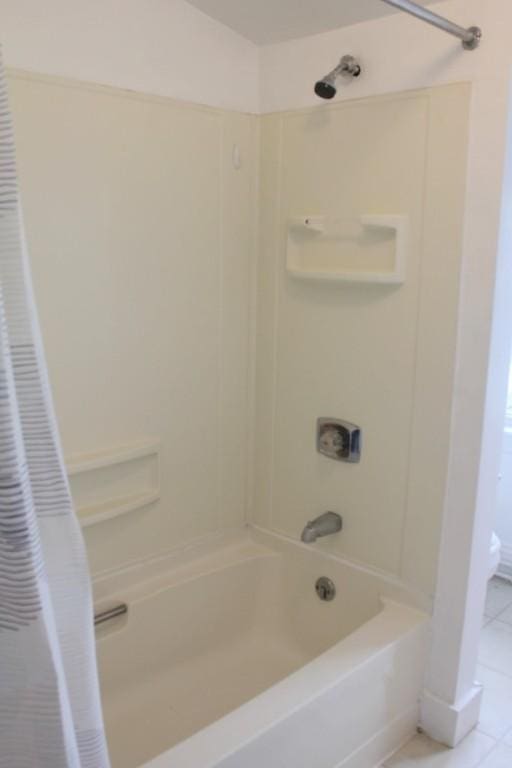 bathroom with tile patterned flooring and shower / tub combo