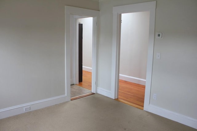 carpeted spare room with baseboards