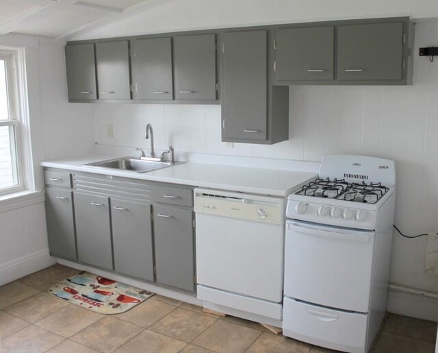 kitchen featuring a sink, white appliances, light countertops, vaulted ceiling with beams, and gray cabinetry