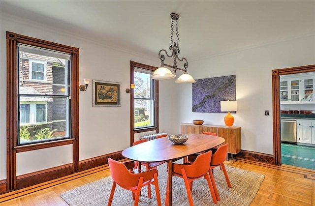 dining room with baseboards and ornamental molding