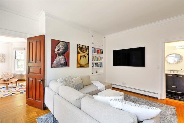 living room with a baseboard radiator, ornamental molding, and light wood-style flooring