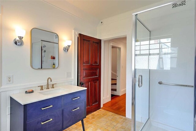 full bath featuring vanity and a shower stall