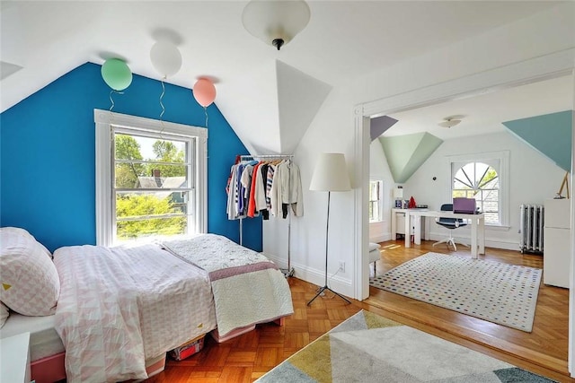 bedroom with radiator, baseboards, and lofted ceiling