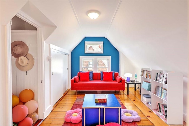 recreation room with vaulted ceiling and hardwood / wood-style flooring