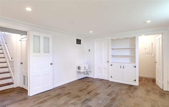 interior space with recessed lighting, heating unit, and light wood-style flooring