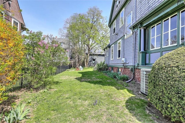 view of yard featuring fence and cooling unit