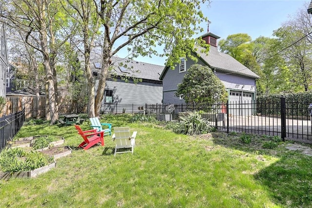 view of yard featuring a fenced backyard and a garden