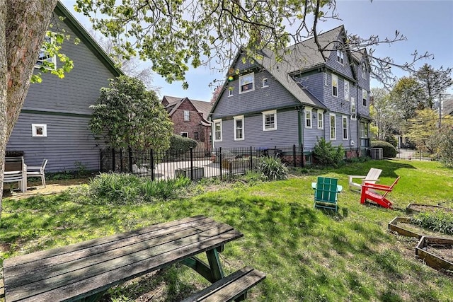 back of house with a lawn, central AC, and fence