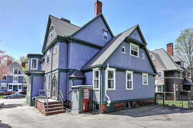 exterior space with fence and a chimney