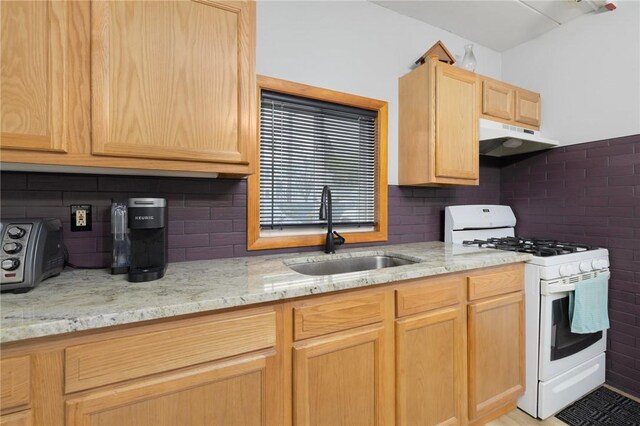 94 Cowesett Ave Unit 1, West Warwick, RI 02893 - kitchen with decorative backsplash, a sink, white range with gas cooktop, light brown cabinets, and under cabinet range hood