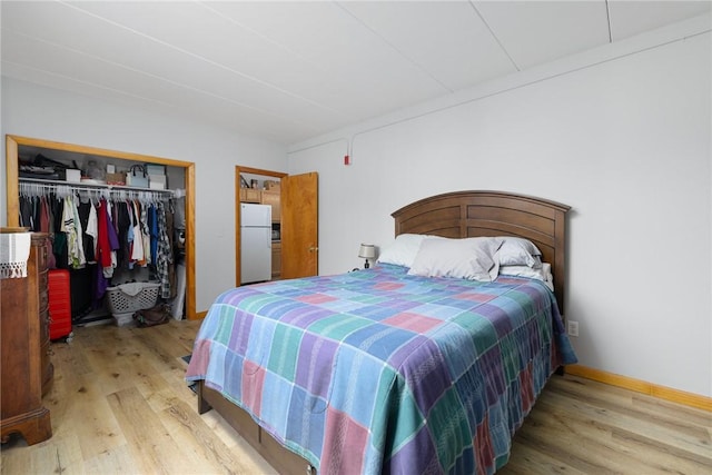 94 Cowesett Ave Unit 1, West Warwick, RI 02893 - bedroom featuring freestanding refrigerator, wood finished floors, and a closet