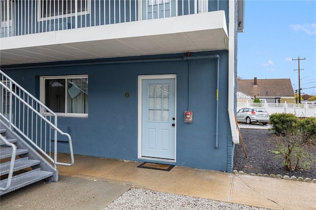 94 Cowesett Ave Unit 1, West Warwick, RI 02893 - doorway to property with stucco siding and fence