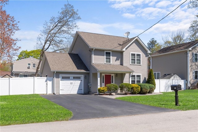 traditional home with a garage, a front lawn, aphalt driveway, fence, and roof with shingles