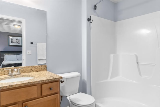 bathroom featuring vanity, walk in shower, ensuite bath, and toilet