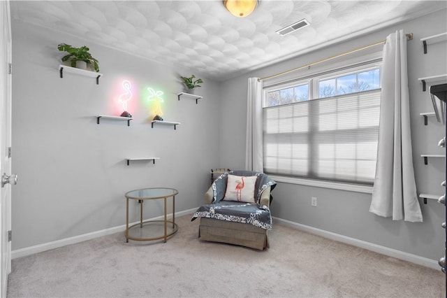 sitting room with carpet floors, baseboards, and visible vents