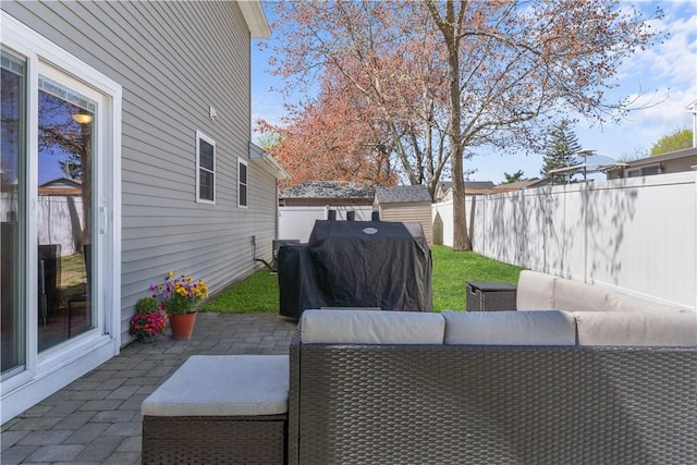 view of patio with a fenced backyard, area for grilling, and outdoor lounge area